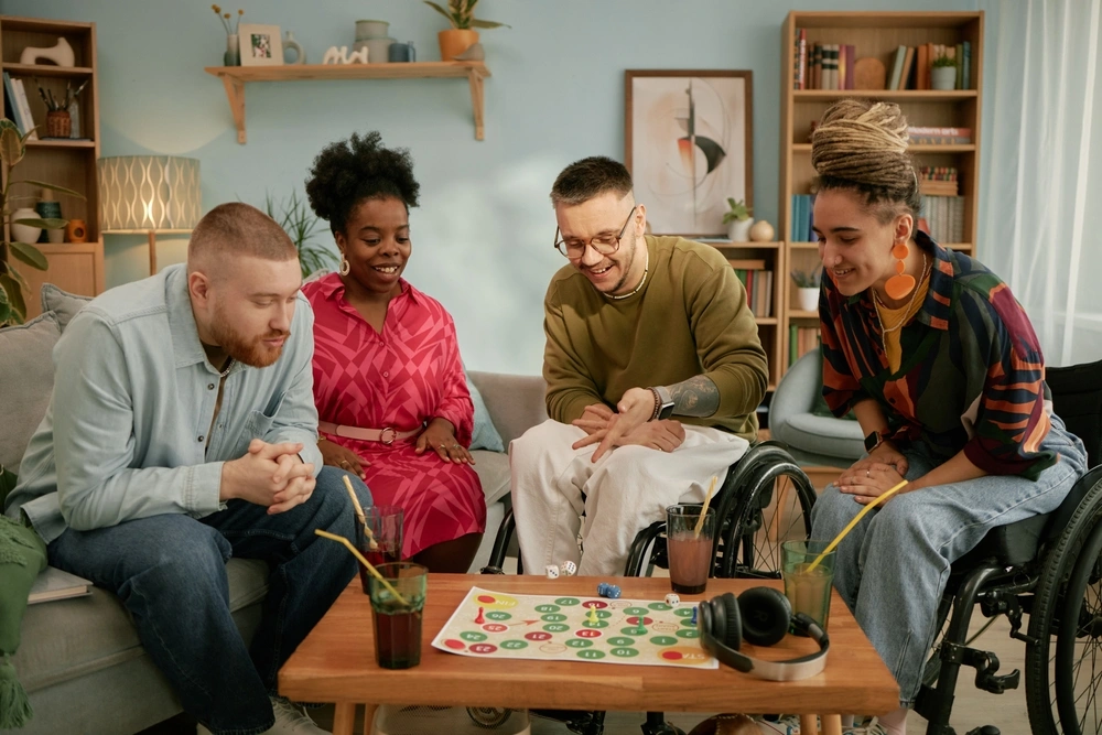 Group of disabled and diverse friends playing board game