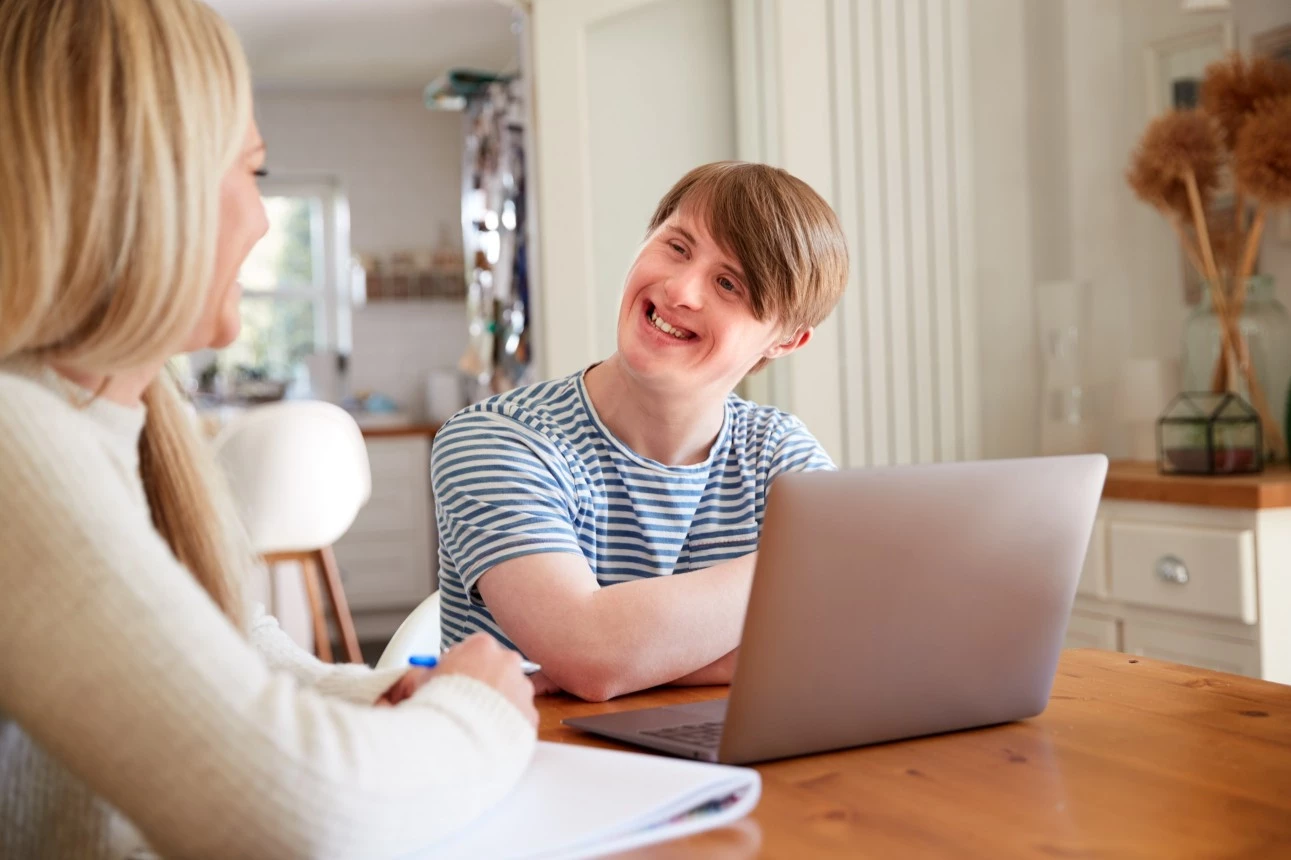 Disabled man smiling at carer
