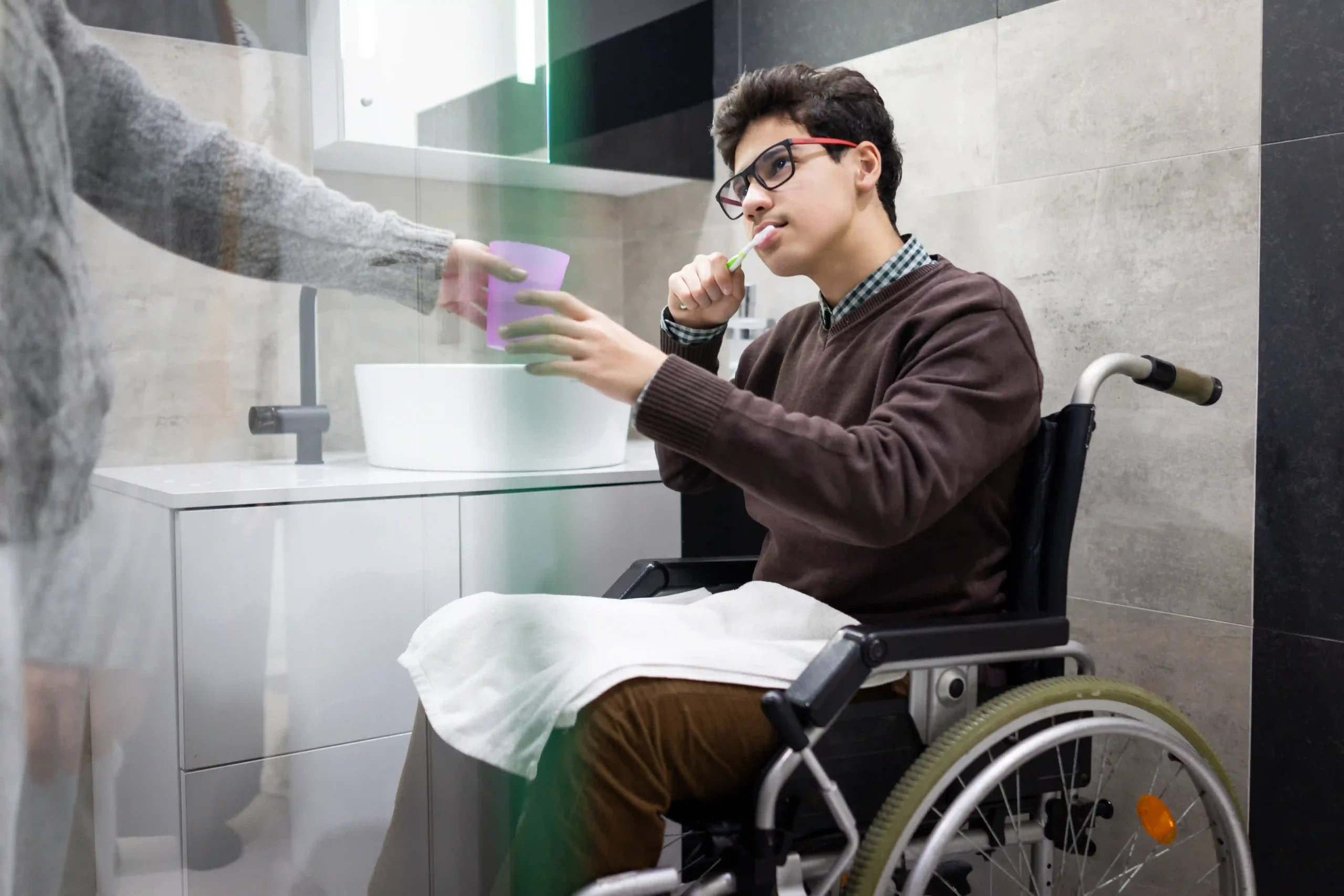 Disabled man in wheelchair brushing teeth