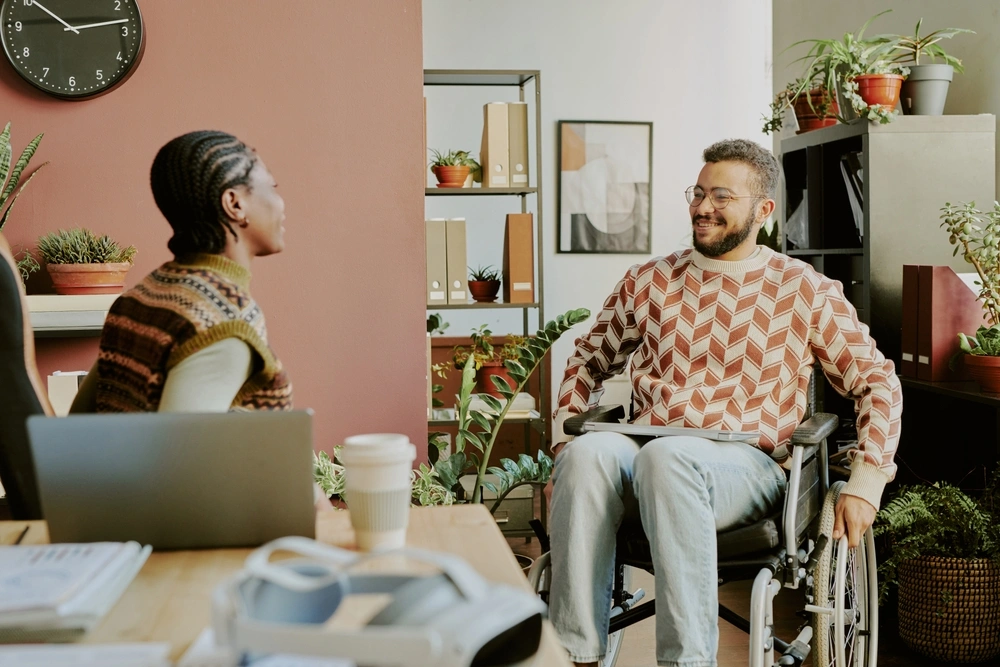 Support worker talking with disabled man in wheelchair