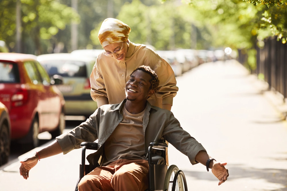 Disabled man in wheelchair with support worker